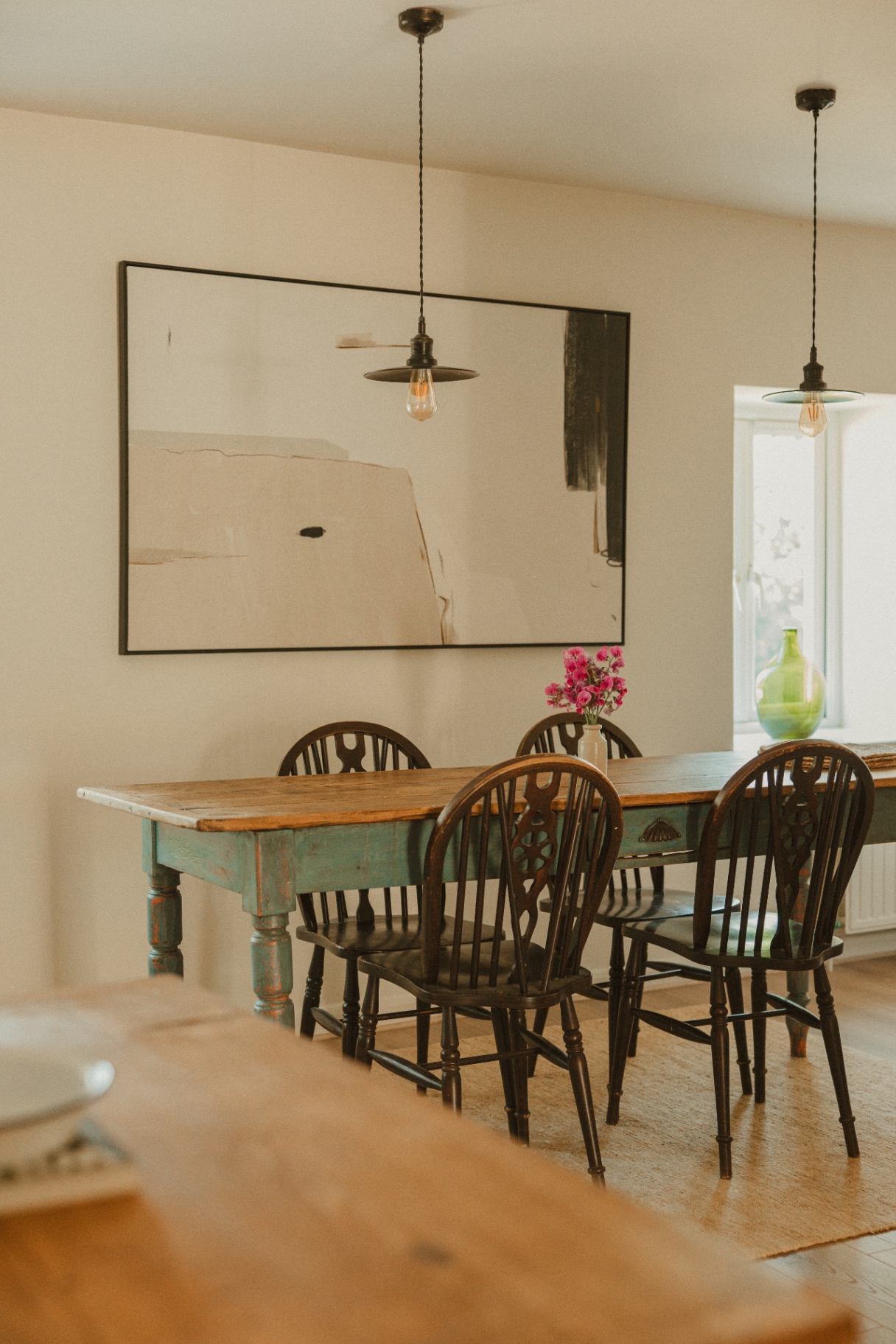 The Guesthouse - rustic dining table with wheelback chairs and pendant lighting