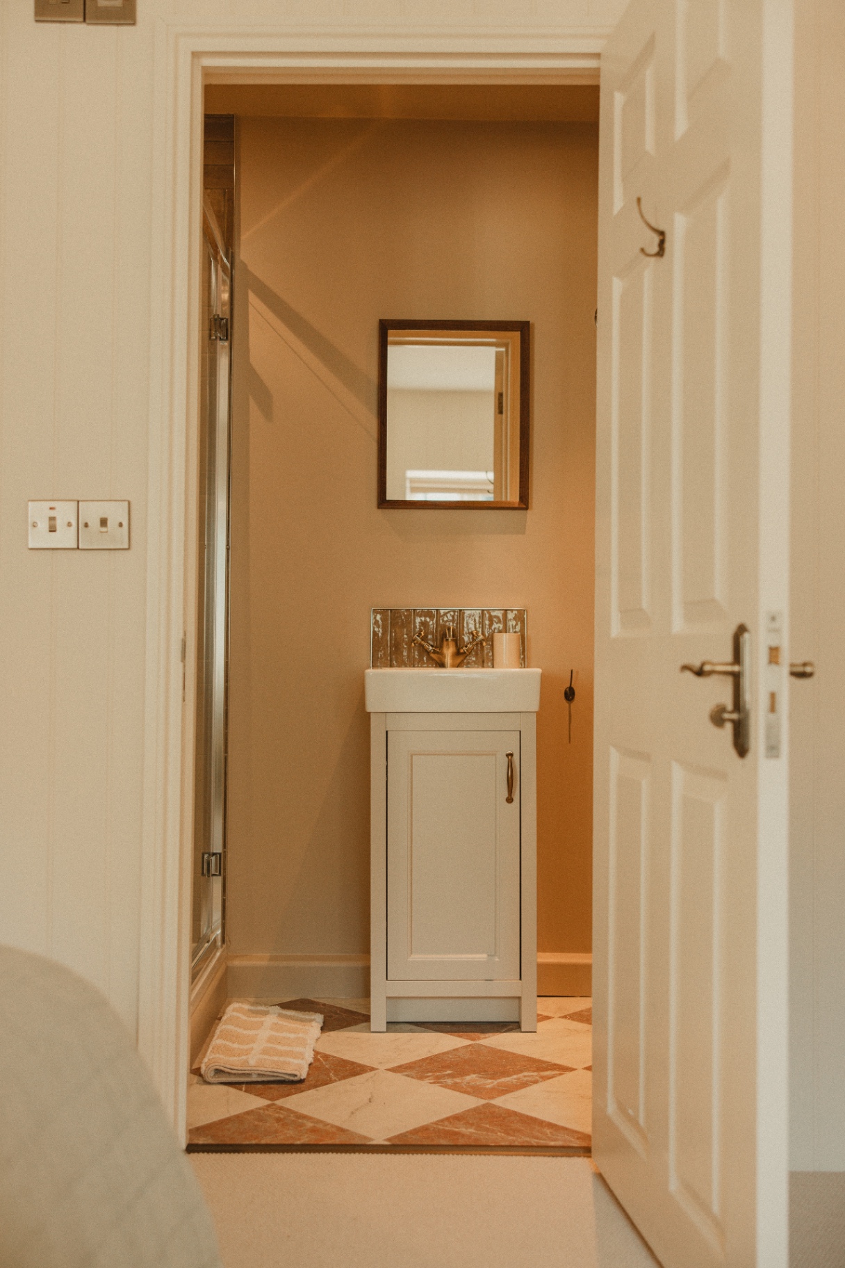 The Guesthouse - ensuite with terracotta diamond tiled floor and brass fittings
