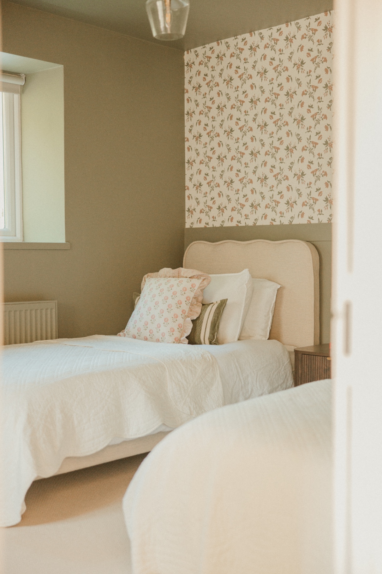The Guesthouse - twin bedroom with floral wallpaper and soft green walls
