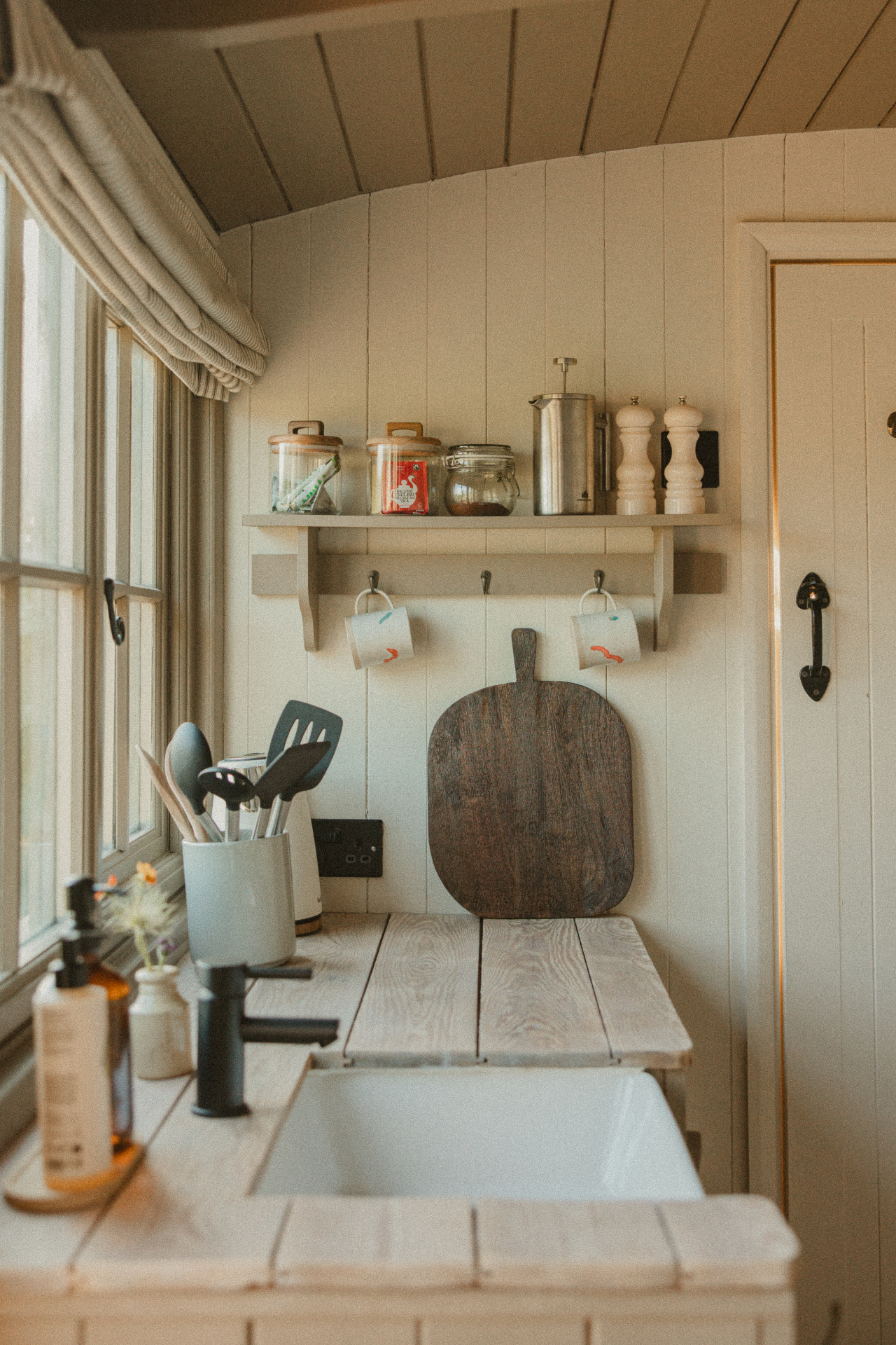 Willow - interior view across kitchen, woodburner and dish shelf