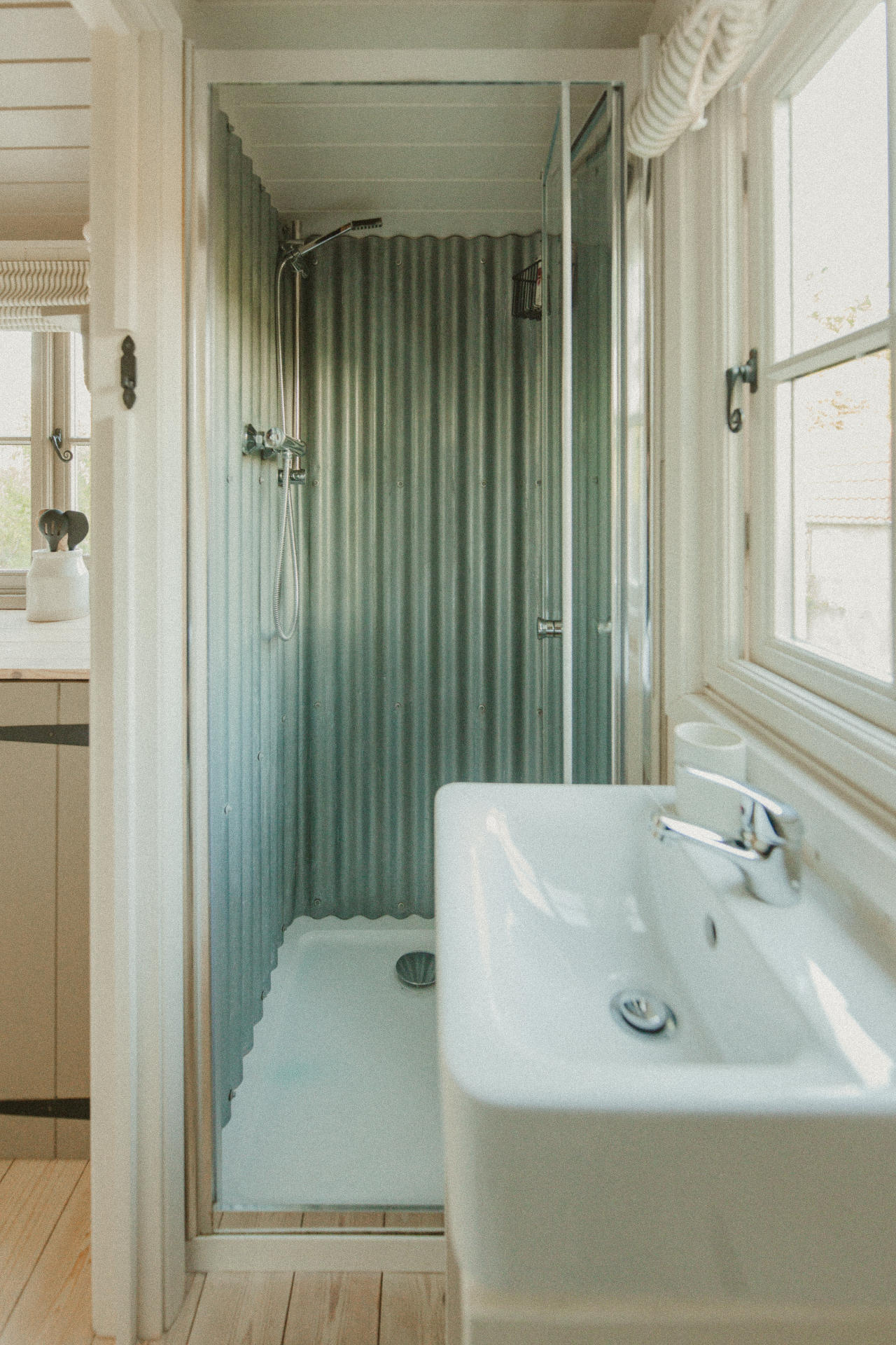 Fern - en-suite shower room with sink and corrugated metal walls